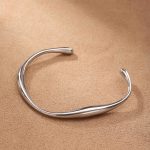 Silver Fluid Curve Stainless Steel Bangle – Modern Sculptural Style - Image 4